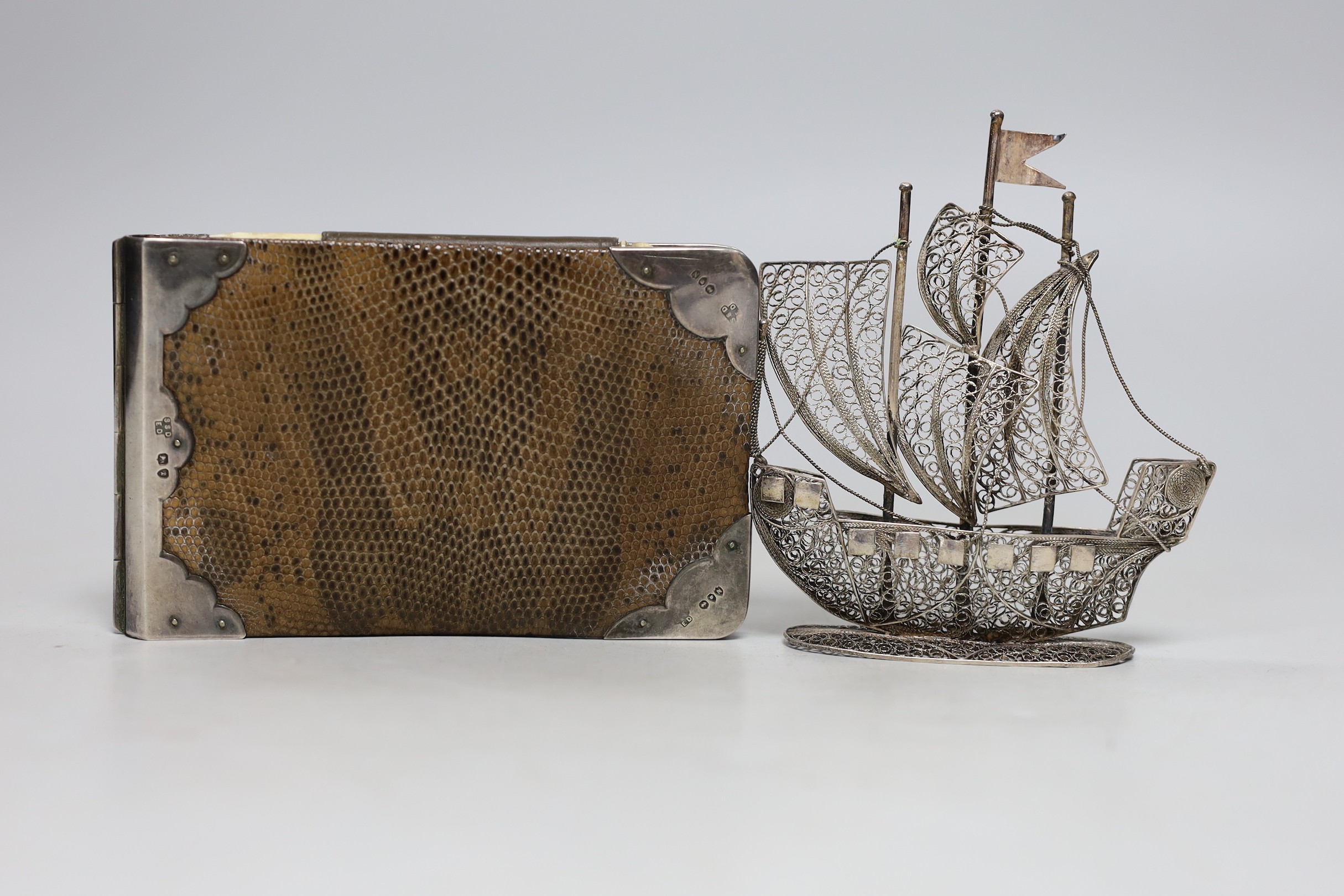 A silver mounted hinged folding wallet, 7.5 x 12cm, together with a filigree ship, a gilt and blue Limoges box and two animal figures